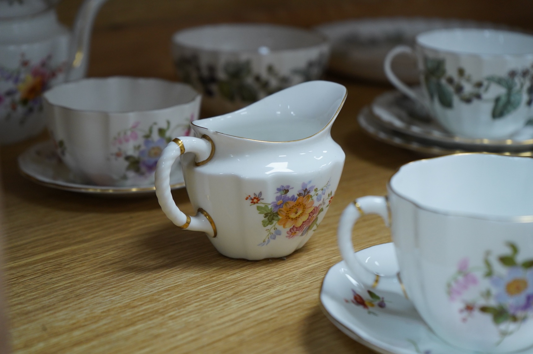 A Royal Crown Derby tea for two set, and a Royal Worcester Lavinia pattern part tea set to include trios, largest 20cm wide